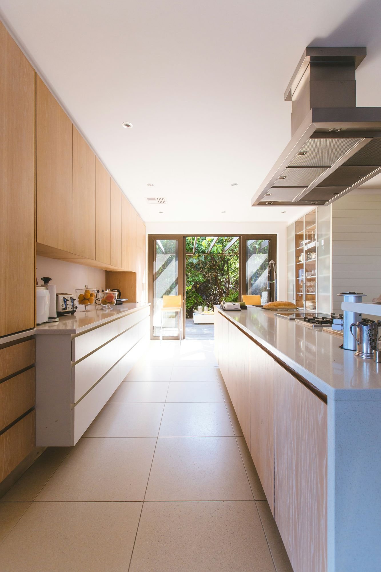 Bright kitchen with white island and glass doors
